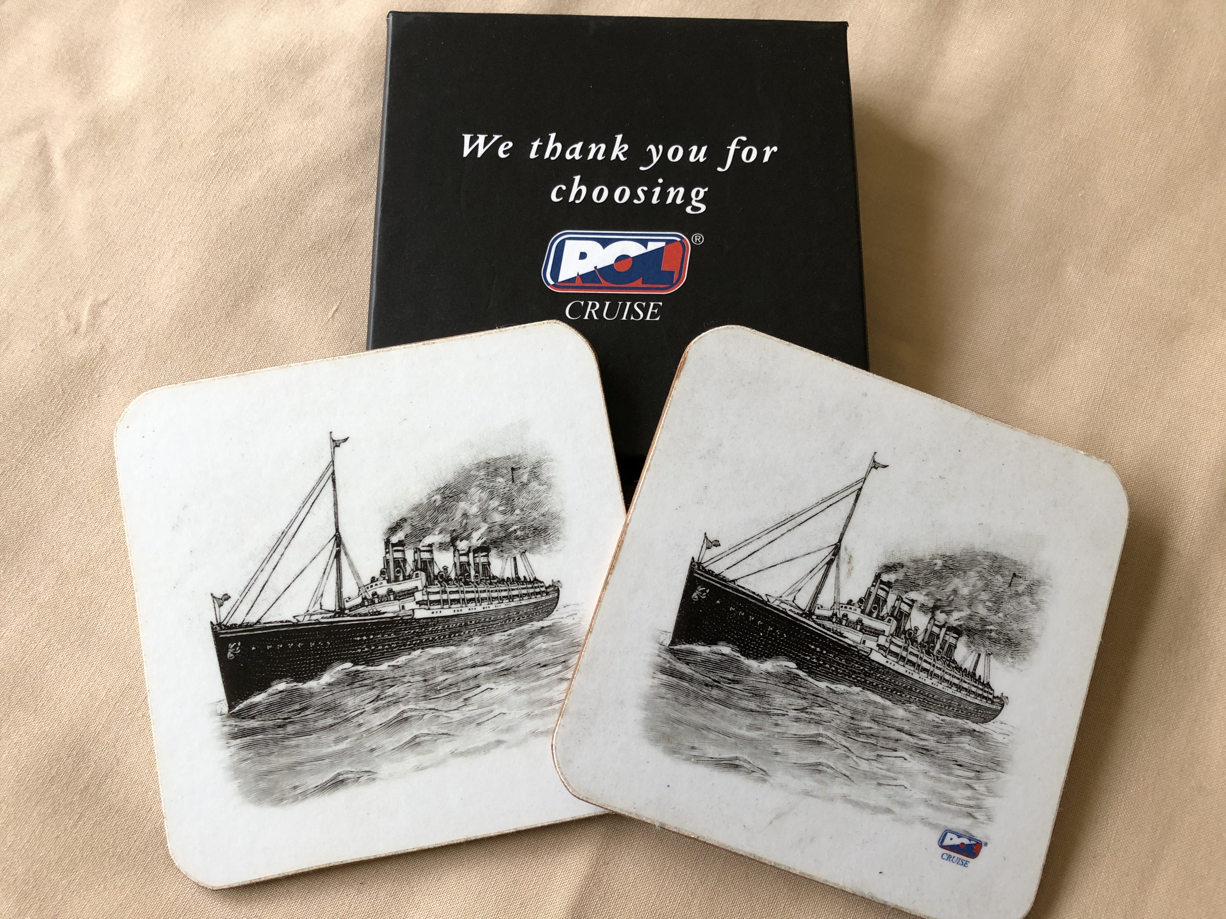 PAIR OF SOUVENIR MATS FROM THE ROL CRUISE BOOKING COMPANY