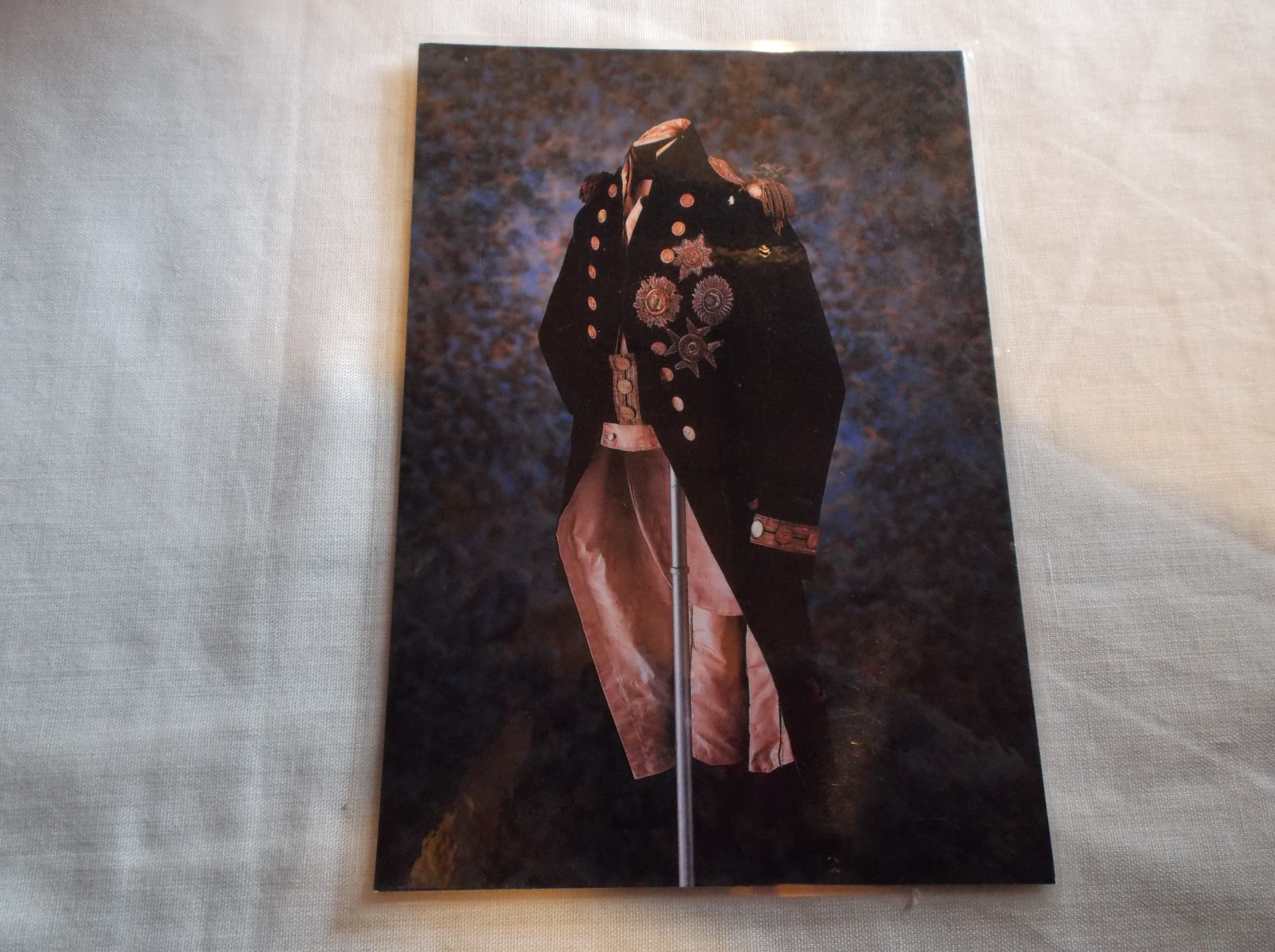 POSTCARD OF A BATTLE OF TRAFALGAR OFFICERS UNIFORM PRODUCED ON A LAMINATED POSTCARD 