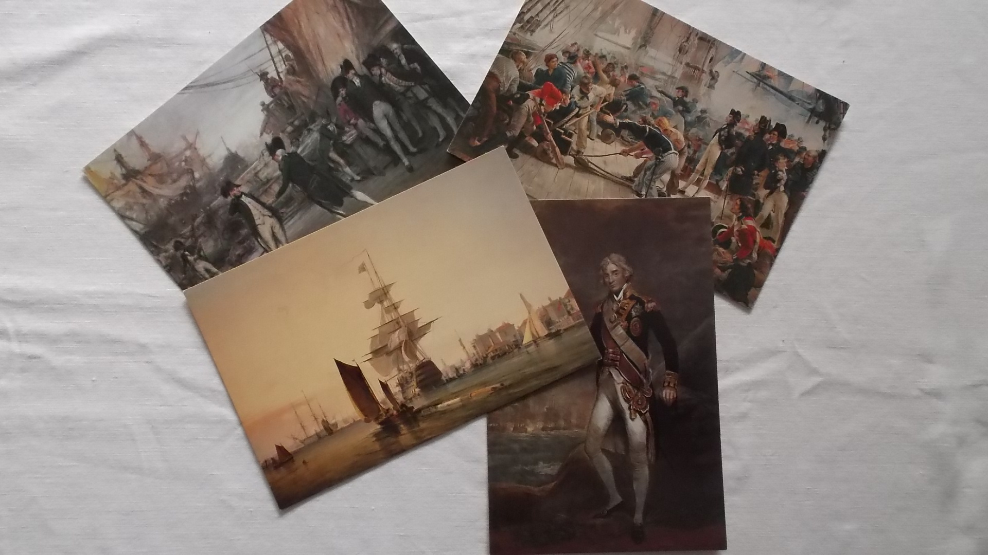 SET OF 4 SOUVENIR POSTCARDS COMMEMORATING SCENES FROM THE BATTLE OF TRAFALGAR